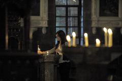 A worshipper lights a candle in St. Paul's Melkite Greek Catholic Church in Damascus, Syria.