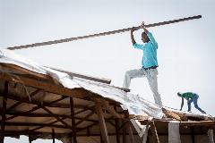 CAR refugee Moussa Inoussa helps to dismantle a building in the Ngam refugee camp. Deemed unsafe for use after days of strong wind, the building must be torn down and rebuilt in order to serve again as a distribution for food and other materials to the refugees. Supported by the Lutheran World Federation, the Ngam refugee camp, located in the Meiganga municipality, Adamaoua region of Cameroon, hosts 7,228 refugees from the Central African Republic