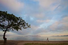 A man runs along the seashore early in the morning in Barcelona, Venezuela.