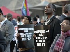 Participants in the 20th International AIDS Conference in Melbourne, Australia, march through the streets of the city holding signs commemorating six conference delegates who died when Malaysia Airlines flight 17 was shot down over Ukraine on the eve of the gathering.